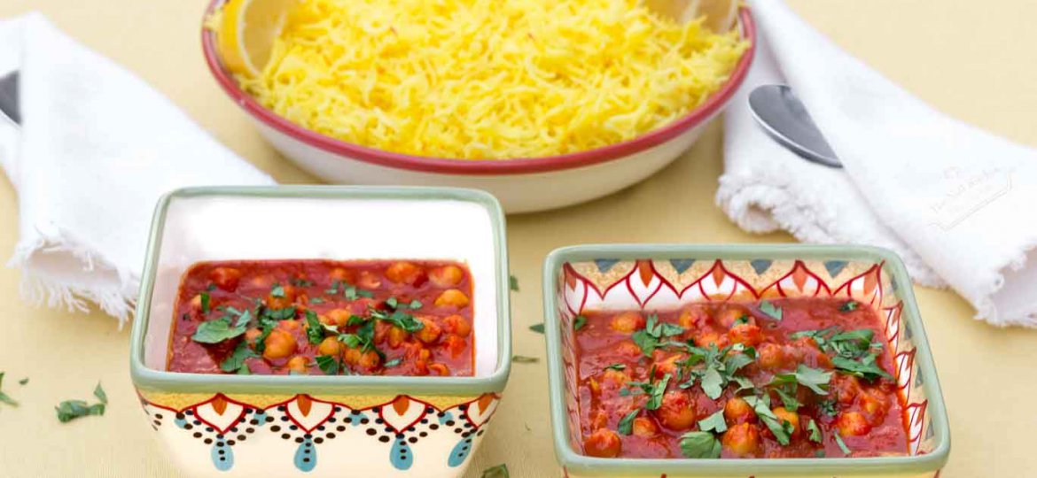 Two hand-painted bowls of Moroccan Inspired Warm-spiced Chickpeas with a bowl of Saffron & Lemon Infused Rice behind