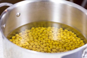 Dried Chickpeas in a large pot just before boiling