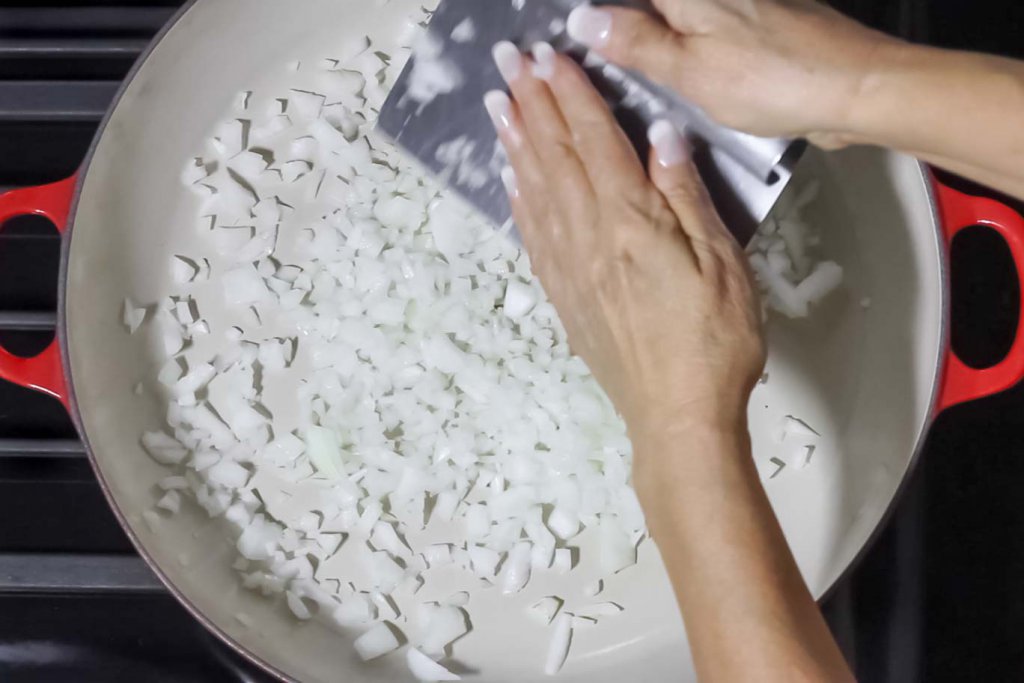 Using a Pastry Scraper to pick up the chopped onion to move