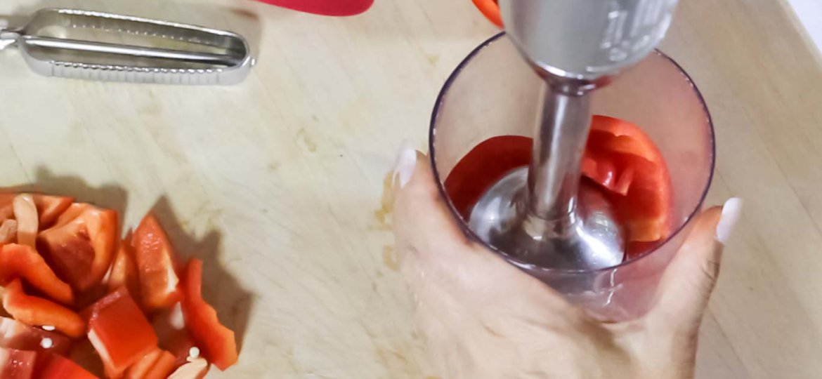 Kitchen Aid Hand Blender with a fresh red bell pepper in the cup ready to be blended.