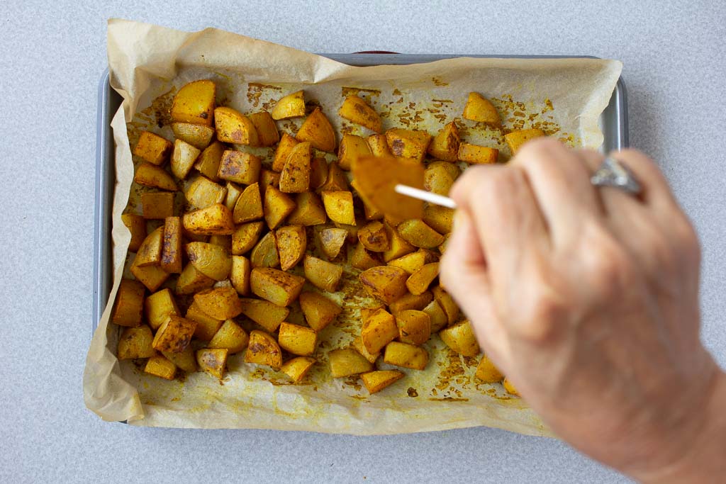 Check if the potatoes are done by pushing a toothpick through a couple of pieces