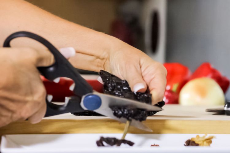 01 Removing the stem and seeds from the ancho with kitchen shears