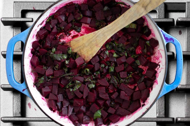 Balsamic vinegar added to the braiser pan with cooked beets and stalks