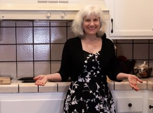 Cathy O'hagain in a kitchen with white cabinets